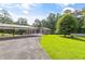 Exterior of home with large yard, extended driveway, and attached carport at 4847 Lakewood Dr, Acworth, GA 30101