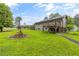 View of backyard with firepit, green lawn and house with elevated deck at 4847 Lakewood Dr, Acworth, GA 30101