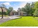 Exterior of home showcasing expansive yard space, driveway, carport, and combination of brick and siding at 4847 Lakewood Dr, Acworth, GA 30101