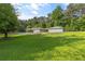 Beautifully landscaped front yard and exterior of home with attached carport and driveway at 4847 Lakewood Dr, Acworth, GA 30101