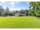 Spacious front yard and exterior of home with attached garage and long paved driveway at 4847 Lakewood Dr, Acworth, GA 30101