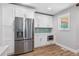 Modern kitchen featuring stainless fridge and microwave and white cabinets with great natural lighting at 4847 Lakewood Dr, Acworth, GA 30101