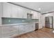 Bright kitchen featuring white cabinets, stainless appliances, and light countertops with tile backsplash at 4847 Lakewood Dr, Acworth, GA 30101