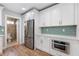 Modern kitchen boasts stainless appliances, white cabinets, and bright countertops, conveniently located near a bath at 4847 Lakewood Dr, Acworth, GA 30101