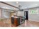 Open kitchen and living area featuring a center island cooktop and stainless appliances with modern finishes at 4847 Lakewood Dr, Acworth, GA 30101