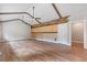 Spacious living area featuring wood floors, ceiling beams, and decorative accent wall at 4847 Lakewood Dr, Acworth, GA 30101