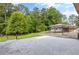View from a large patio to the house, garage, carport and a grassy lawn at 4847 Lakewood Dr, Acworth, GA 30101