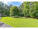 Expansive backyard with lush lawn and mature trees offering privacy at 4847 Lakewood Dr, Acworth, GA 30101