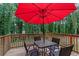 Back deck with a table, four chairs, and a red umbrella at 6372 Valley Dale Dr, Riverdale, GA 30274