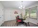 Cozy dining area with modern chandelier, glass-topped table, and comfortable seating at 6372 Valley Dale Dr, Riverdale, GA 30274