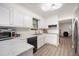 Bright kitchen with white cabinets, stainless steel appliances, and marbled countertops at 6372 Valley Dale Dr, Riverdale, GA 30274
