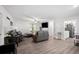 Open-concept living area featuring wood-look floors, ample seating, and access to the kitchen at 6372 Valley Dale Dr, Riverdale, GA 30274