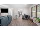 Spacious living area featuring wood-look floors, a dedicated workspace, and natural light at 6372 Valley Dale Dr, Riverdale, GA 30274