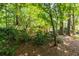 Lush backyard with mature trees and landscaping create a private and serene outdoor oasis at 1192 Cleburne Ne Ave, Atlanta, GA 30307