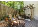 Outdoor patio boasts wooden chairs and dining under a wood pergola at 1192 Cleburne Ne Ave, Atlanta, GA 30307