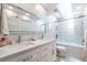This bathroom features marble counters, double sinks, and a shower with glass doors at 1192 Cleburne Ne Ave, Atlanta, GA 30307