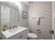 Charming powder room with decorative tiled accent wall, white vanity, and modern fixtures at 1192 Cleburne Ne Ave, Atlanta, GA 30307