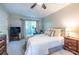 Cozy bedroom with large bed, accent pillows, television, and exercise bike at 1192 Cleburne Ne Ave, Atlanta, GA 30307