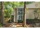 Home exterior showcasing a modern wall of windows, a covered porch and mature trees at 1192 Cleburne Ne Ave, Atlanta, GA 30307