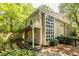 Exterior side view of a home with a deck, stone pathway, and expansive windows at 1192 Cleburne Ne Ave, Atlanta, GA 30307