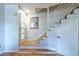 Bright foyer with wood floors, modern staircase, and stylish front door at 1192 Cleburne Ne Ave, Atlanta, GA 30307