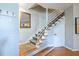 Foyer featuring wood floors, a modern staircase, and a decorative mirror at 1192 Cleburne Ne Ave, Atlanta, GA 30307