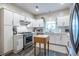 Bright kitchen featuring stainless steel appliances, white cabinets, and tile backsplash at 1192 Cleburne Ne Ave, Atlanta, GA 30307