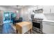 Open concept kitchen featuring stainless steel appliances, white cabinets, and a dining area near the window at 1192 Cleburne Ne Ave, Atlanta, GA 30307