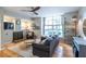 Open-concept living room with a large window and a fireplace, perfect for relaxation and entertaining at 1192 Cleburne Ne Ave, Atlanta, GA 30307