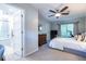 This is a bedroom with a ceiling fan, a large bed, and an open door to the bathroom at 1192 Cleburne Ne Ave, Atlanta, GA 30307