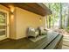 Cozy covered patio featuring comfortable seating, warm lighting, and a stylish rug at 1192 Cleburne Ne Ave, Atlanta, GA 30307