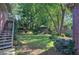 Beautiful backyard with lush landscaping, mature trees, and a charming gazebo at 2160 Kensington Gates Nw Dr, Kennesaw, GA 30152