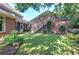 Brick house has a well-manicured backyard and a view of a calming rock water feature at 2160 Kensington Gates Nw Dr, Kennesaw, GA 30152