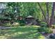 Lush backyard features a gazebo, mature trees, and meticulously maintained landscaping at 2160 Kensington Gates Nw Dr, Kennesaw, GA 30152