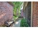 Inviting backyard with bench, screened porch, garden path, and lush landscaping, perfect for relaxation at 2160 Kensington Gates Nw Dr, Kennesaw, GA 30152
