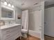 Bright bathroom featuring a vanity with a marble countertop, neutral tiling and a shower-tub combination at 2160 Kensington Gates Nw Dr, Kennesaw, GA 30152