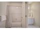 Bathroom featuring a shower/tub with patterned curtain and a separate vanity area at 2160 Kensington Gates Nw Dr, Kennesaw, GA 30152