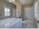 Bathroom featuring a vanity and shower with curtain and window for natural lighting at 2160 Kensington Gates Nw Dr, Kennesaw, GA 30152