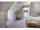 Bedroom featuring vaulted ceilings, neutral walls, and a cozy rocking chair by the window at 2160 Kensington Gates Nw Dr, Kennesaw, GA 30152