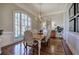 Sunlit dining room with hardwood floors, a large window, chandelier, and ample seating at 2160 Kensington Gates Nw Dr, Kennesaw, GA 30152