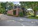Brick home featuring mature trees, lush landscaping, and expansive driveway, creating a serene setting at 2160 Kensington Gates Nw Dr, Kennesaw, GA 30152