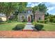 Charming home exterior featuring mature landscaping, inviting entryway, and a red front door at 2160 Kensington Gates Nw Dr, Kennesaw, GA 30152