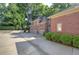 Expansive driveway leads to a three-car garage with lush greenery surrounding the exterior, offering privacy at 2160 Kensington Gates Nw Dr, Kennesaw, GA 30152