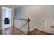 Hallway with wood floors and staircase leading to other rooms at 2160 Kensington Gates Nw Dr, Kennesaw, GA 30152