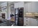 Modern kitchen featuring stainless steel refrigerator, granite countertops and beautiful tile backsplash at 2160 Kensington Gates Nw Dr, Kennesaw, GA 30152