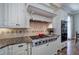 Gourmet kitchen featuring a gas range, granite countertops, custom cabinets, and hardwood flooring at 2160 Kensington Gates Nw Dr, Kennesaw, GA 30152