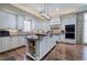 Bright kitchen with island, granite countertops, white cabinets, stainless appliances, and hardwood flooring at 2160 Kensington Gates Nw Dr, Kennesaw, GA 30152