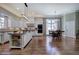 Open kitchen and dining area with hardwood floors, central island and granite countertops at 2160 Kensington Gates Nw Dr, Kennesaw, GA 30152