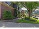 Landscaped exterior featuring lush greenery, stone accents, and mature trees along a sidewalk at 2160 Kensington Gates Nw Dr, Kennesaw, GA 30152