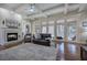 Spacious living room with fireplace, coffered ceiling, ample windows, and comfortable seating at 2160 Kensington Gates Nw Dr, Kennesaw, GA 30152